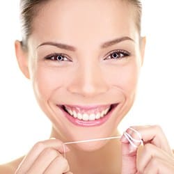 Smiling woman holding dental floss