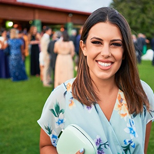 Wedding guest smiling outside