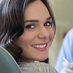 A female patient in the dentist chair after Invisalign treatment