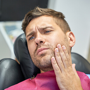 Man with a toothache at the dentist