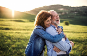 Senior couple enjoying the sunlight in a calming field