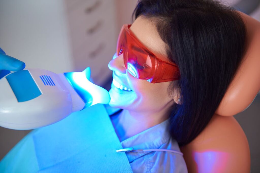 A woman getting a professional tooth whitening treatment